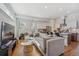 Bright living room featuring a spacious couch, hardwood floors, and an open concept kitchen at 1216 Perry St, Denver, CO 80204