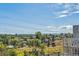 Scenic view of trees and distant mountains from a high vantage point with blue skies above at 1216 Perry St, Denver, CO 80204