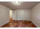 An open bedroom features red tile floors, closet, and open door to hallway at 3722 Monterey Pl, Boulder, CO 80301