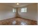 Bright bedroom with tile flooring, natural lighting, and two windows at 3722 Monterey Pl, Boulder, CO 80301