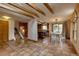 Spacious dining room featuring a skylight, exposed beams, and terra cotta flooring adjacent to the kitchen for easy access at 3722 Monterey Pl, Boulder, CO 80301