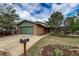 Charming brick home boasts a well-manicured front yard, mature trees, and a convenient two-car garage, creating curb appeal at 3722 Monterey Pl, Boulder, CO 80301