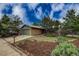 Beautiful front exterior of brick house with a two car garage, mature trees, and a well manicured lawn at 3722 Monterey Pl, Boulder, CO 80301