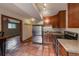 Kitchen with stainless steel appliances, wood cabinets and terra cotta tile floors at 3722 Monterey Pl, Boulder, CO 80301