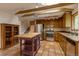 Updated kitchen with stainless steel appliances, butcher block island, terra cotta tile, and light wood cabinetry at 3722 Monterey Pl, Boulder, CO 80301