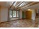 Bright living room featuring a large window, terra cotta tile flooring, and beamed ceilings with skylights at 3722 Monterey Pl, Boulder, CO 80301