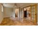 Open living area with terra cotta tile floors and doorway to stairs and open french doors to kitchen at 3722 Monterey Pl, Boulder, CO 80301