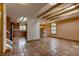 Open-concept living and kitchen area featuring terra cotta floors, wood beams, and bright, natural light from skylights and windows at 3722 Monterey Pl, Boulder, CO 80301
