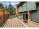 Back patio of house with concrete and brickwork leading to basement door at 3722 Monterey Pl, Boulder, CO 80301