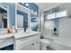 Beautiful bathroom with white subway tile, blue accent wall, and glass shower at 4702 S Biscay Ct, Aurora, CO 80015