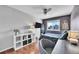 Bedroom features wood floors, ceiling fan, and decorative items on shelving unit at 4702 S Biscay Ct, Aurora, CO 80015