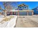 Two-story home featuring a three-car garage and blue siding at 4702 S Biscay Ct, Aurora, CO 80015