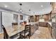 Kitchen area with a large island, seating, and modern fixtures at 4702 S Biscay Ct, Aurora, CO 80015