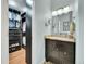 Elegant bathroom featuring granite countertop, dark cabinets, and walk-in closet at 4702 S Biscay Ct, Aurora, CO 80015