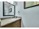 Stylish powder room with granite countertop, modern fixtures, and fresh paint at 4702 S Biscay Ct, Aurora, CO 80015