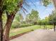 View of the home's backyard featuring a concrete patio and green space at 13561 W Alaska Pl, Lakewood, CO 80228