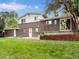 Exterior view of the home's backyard with a brick facade and well-maintained lawn at 13561 W Alaska Pl, Lakewood, CO 80228