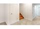 Finished basement featuring a closet, door to the stairs, and access to storage at 13561 W Alaska Pl, Lakewood, CO 80228