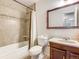 Cozy bathroom featuring tile floors, a vanity, and a shower-tub combo at 13561 W Alaska Pl, Lakewood, CO 80228