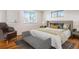 Comfortable bedroom featuring a stylish chair, bench, area rug, and natural light with a view from the window at 13561 W Alaska Pl, Lakewood, CO 80228