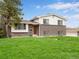 Charming brick home featuring a well-manicured lawn and inviting curb appeal at 13561 W Alaska Pl, Lakewood, CO 80228