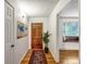 Inviting hallway with hardwood floors, leading to a cozy living area and bedroom at 13561 W Alaska Pl, Lakewood, CO 80228