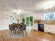 Bright kitchen with hardwood floors, stainless appliances, and a view of the dining area at 13561 W Alaska Pl, Lakewood, CO 80228