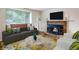 Bright living room with a brick fireplace, stylish furnishings and cozy decor at 13561 W Alaska Pl, Lakewood, CO 80228