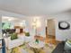 Open concept living room with hardwood floors, stylish furnishings, and ample natural light at 13561 W Alaska Pl, Lakewood, CO 80228