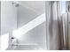 Bright bathroom featuring a shower with sleek white tile surround and modern fixtures at 1930 Grove St # 2, Denver, CO 80204