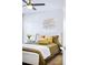 Cozy bedroom featuring a ceiling fan, decorative wall art, and a comfortable bed at 1930 Grove St # 2, Denver, CO 80204