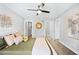 Comfortable bedroom with ceiling fan, modern lighting, and ensuite bathroom at 1930 Grove St # 2, Denver, CO 80204