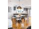 Cozy dining area features modern light fixture and bar seating with views into the kitchen at 1930 Grove St # 2, Denver, CO 80204