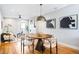 Stylish dining area with a round table, designer lighting, fireplace and modern art at 1930 Grove St # 2, Denver, CO 80204