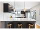 Sleek kitchen with a large island, modern appliances, and stylish backsplash at 1930 Grove St # 2, Denver, CO 80204
