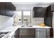 Modern kitchen sink with stainless steel appliances, tile backsplash, and ample counter space at 1930 Grove St # 2, Denver, CO 80204
