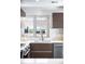 Close-up of the kitchen sink and dishwasher, with modern countertops and tile backsplash at 1930 Grove St # 2, Denver, CO 80204
