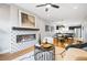 Open-concept living room with a modern fireplace and a seamless flow into the dining and kitchen areas at 1930 Grove St # 2, Denver, CO 80204