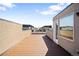 View of the spacious wooden rooftop patio with ample room for outdoor entertainment and lounging at 1930 Grove St # 2, Denver, CO 80204