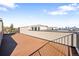 A large wooden rooftop patio offers views of the city skyline and nearby trees at 1930 Grove St # 2, Denver, CO 80204