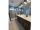 Modern bathroom with a double sink vanity, sleek fixtures, and a glass-enclosed shower at 2142 S Irvington St, Aurora, CO 80018