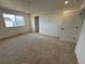 Spacious bedroom with large windows, plush carpet, and ample natural light at 2142 S Irvington St, Aurora, CO 80018