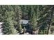 Overhead shot of a house amidst a dense forest, showcasing its peaceful and secluded location at 30094 Upper Bear Creek Rd, Evergreen, CO 80439