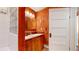 Bathroom with wood paneled vanity and glass block window above the shower at 30094 Upper Bear Creek Rd, Evergreen, CO 80439