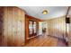 Bedroom featuring wood-paneled walls, hardwood flooring and a set of glass paneled double doors at 30094 Upper Bear Creek Rd, Evergreen, CO 80439