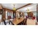 Elegant dining room featuring a large wooden table, vintage decor, and an open floor plan at 30094 Upper Bear Creek Rd, Evergreen, CO 80439
