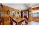 Dining room with hardwood floors, paneled walls, and a large table at 30094 Upper Bear Creek Rd, Evergreen, CO 80439