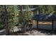 Charming log cabin exterior with a garage surrounded by lush trees at 30094 Upper Bear Creek Rd, Evergreen, CO 80439