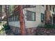 Charming log cabin featuring stone accents and a stone chimney amidst a serene wooded setting at 30094 Upper Bear Creek Rd, Evergreen, CO 80439