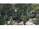 Picturesque view of a home nestled in a wooded area, featuring stone accents and a natural setting at 30094 Upper Bear Creek Rd, Evergreen, CO 80439